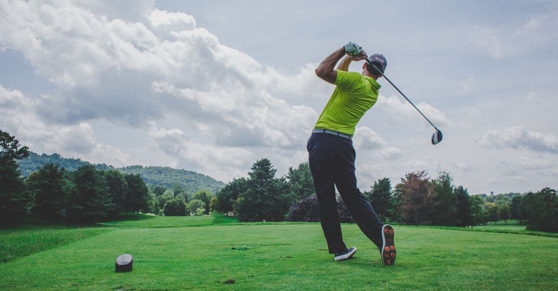 Golfer swinging his driver