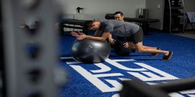 man holding plank on exercise ball