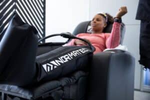 athletic recovery for a woman wearing normatec boots
